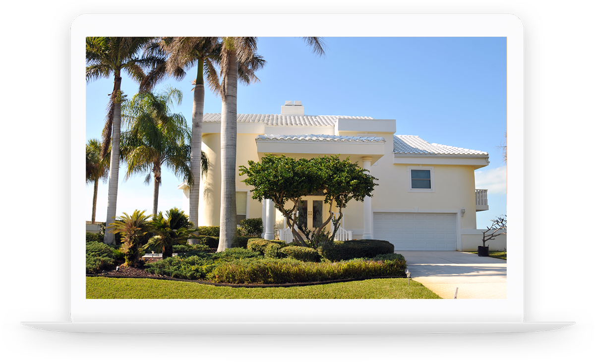 Laptop showing a modern beach house surrounded by palm trees after a home inspection.